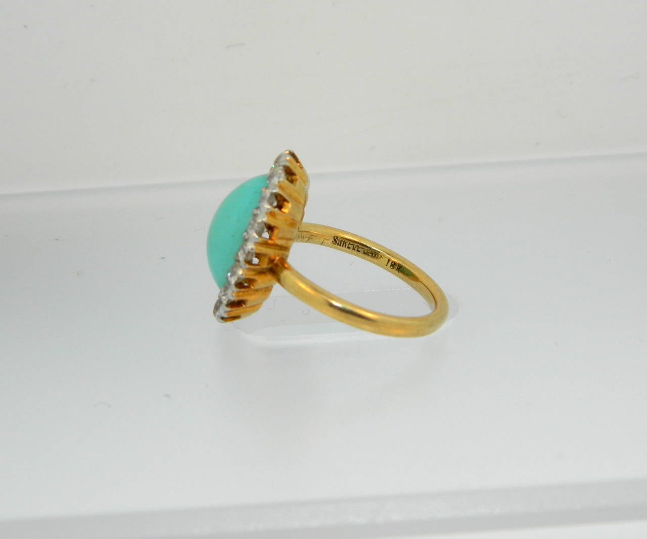 A sweet, early 1900s Turquoise, Diamond, Platinum and Gold cocktail ring by Shreve & Co.
