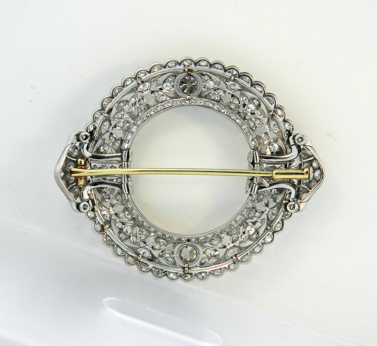 A superb Edwardian, platinum and diamond circle brooch with removable collar clips.