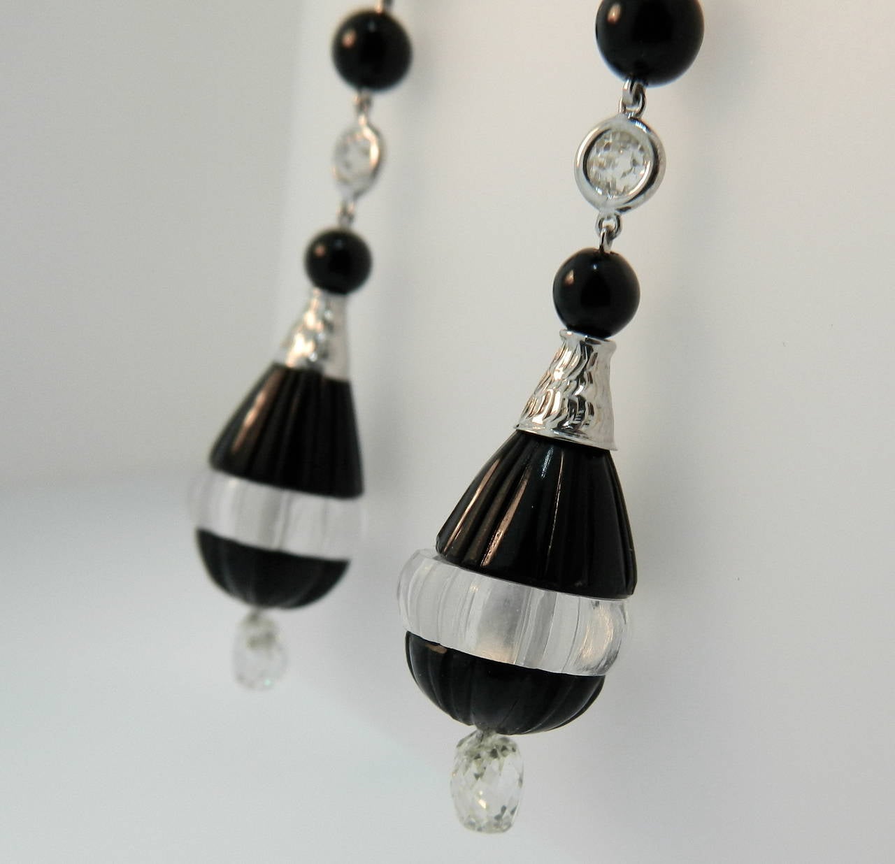A super pair of Art Deco platinum, diamond, onyx and carved rock crystal earrings.  The top two old european cut diamonds have a weight of 2.07cttw.  The bottom two briolette cut diamonds have a weight of 2.10cttw.