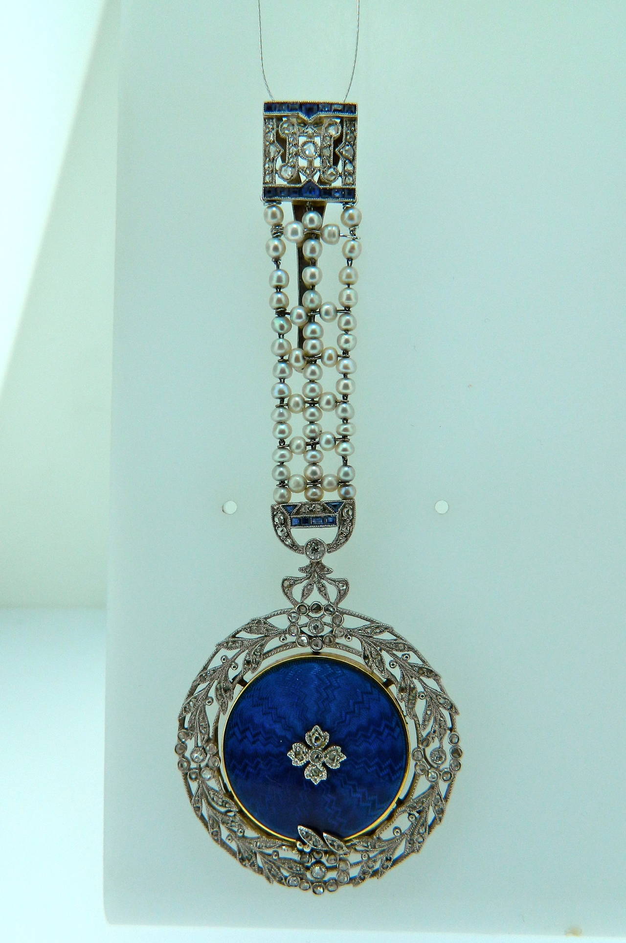 A rare and beautiful French Belle Epoque, Diamond, Natural Pearl, Sapphire, Enamel, Platinum and Gold Locket attributed to Cartier Paris.  French Hallmarks and Numbers.