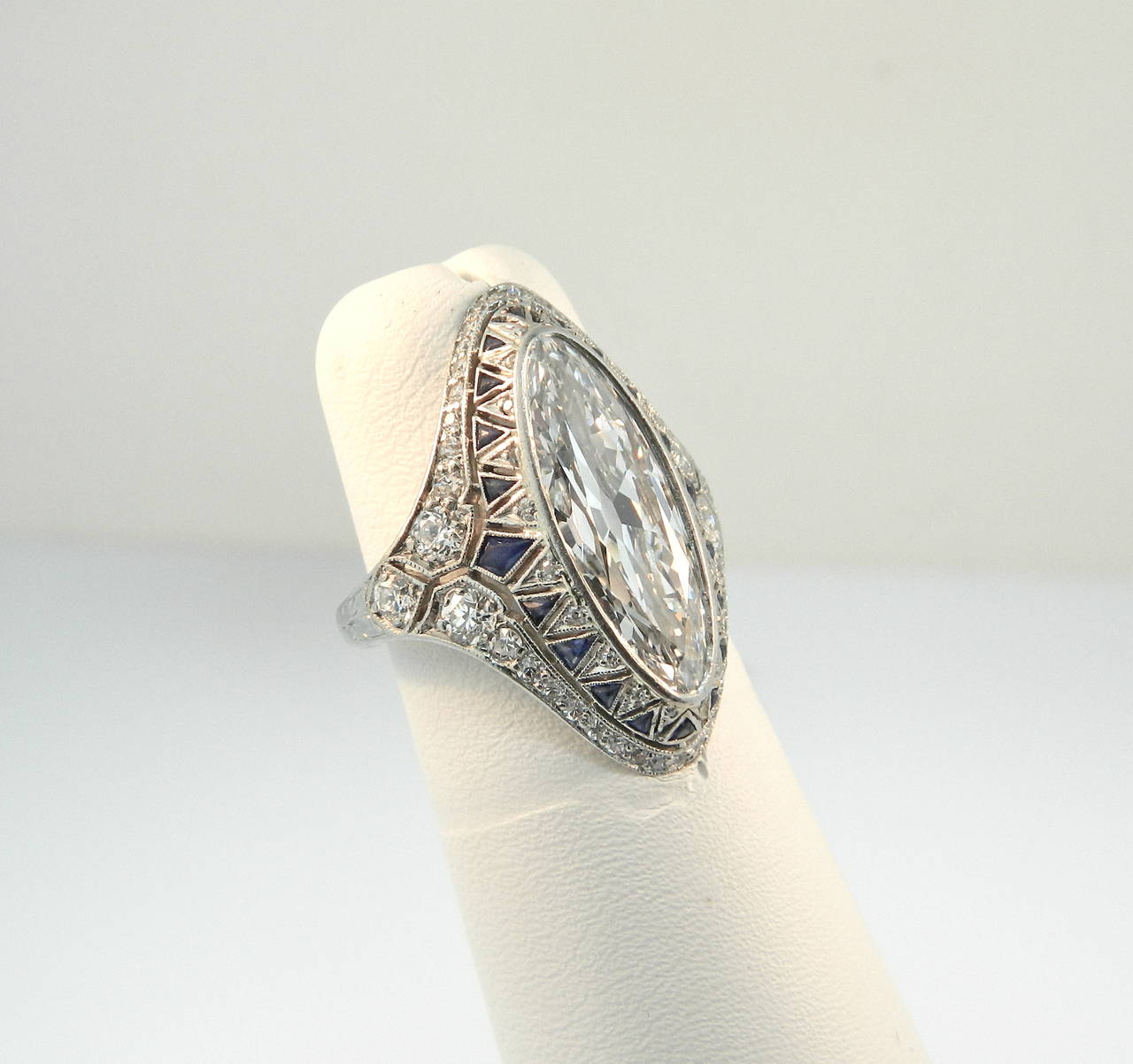 A superb Art Deco Diamond, Sapphire and Platinum ring, featuring a fabulous 3ct (approx) antique oval/marquise cut diamond.  G+ in color and VVS2+ in clarity.