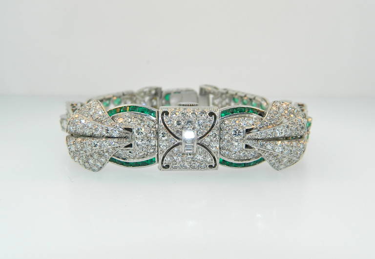 A gorgeous retro period diamond, emerald and platinum surprise watch by Verger Freres Paris.