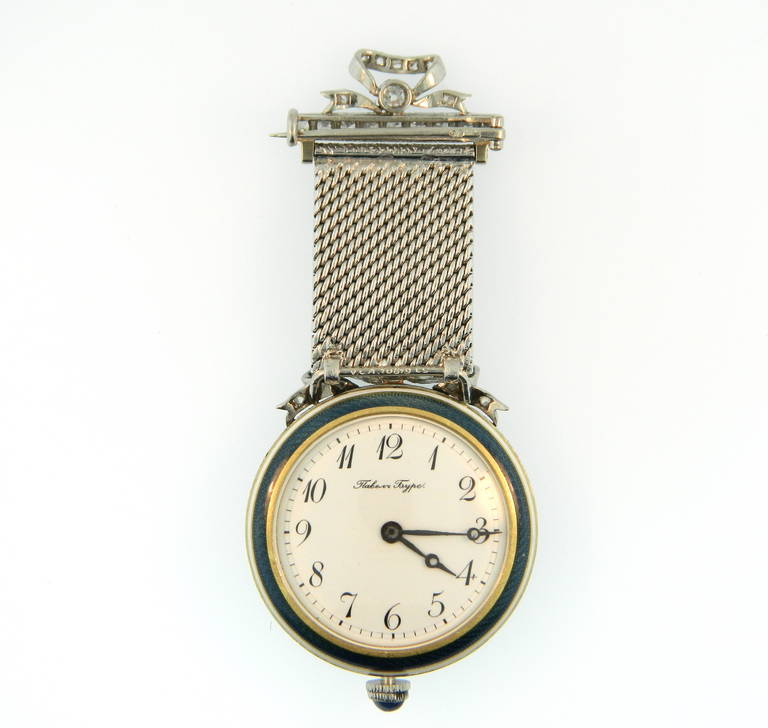 A fabulous and rare yellow gold, platinum, diamond and guilloche enamel lapel watch by Paul Buhre, Retailed by Van Cleef & Arpels. Circa 1910.