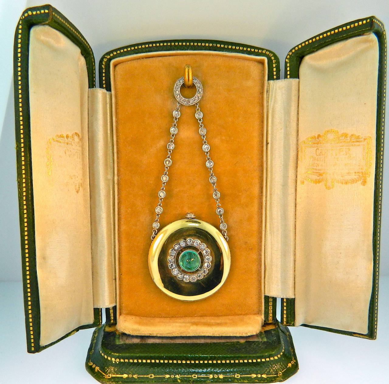 A Stunning Belle Epoque Cartier Paris Diamond, Emerald, Platinum & Gold Watch Pendant in it's original Box.  Circa 1900.  Dial Signed Cartier.  Case with french marks for gold and Cartier Numbers.  Movement signed Cartier (Pre-EWC).