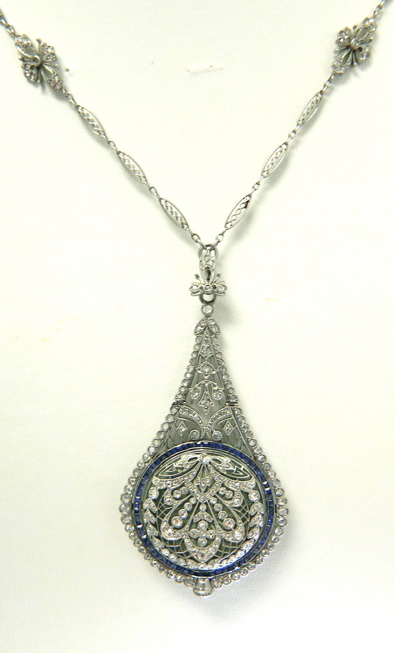 An exquisite Belle Epoque platinum, diamond and sapphire watch pendant by C.H. Meylan. Retailed by J.R. Reed & Co.  Original fitted box.