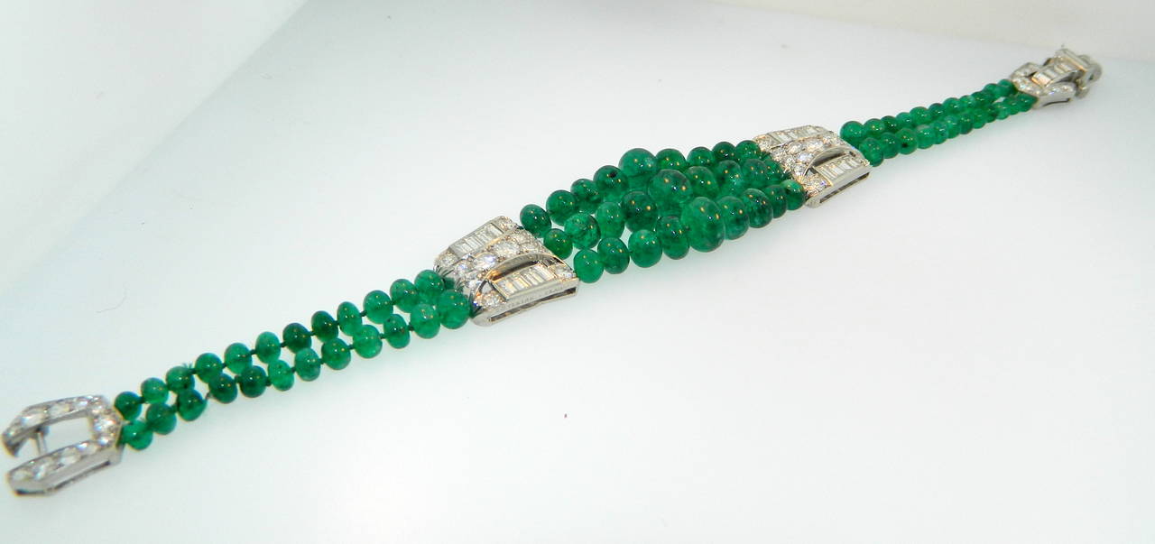 A wonderful 1930s Art Deco platinum, diamond and Columbian emerald bead bracelet by Ostertag France.  Original emerald beads and stringing.