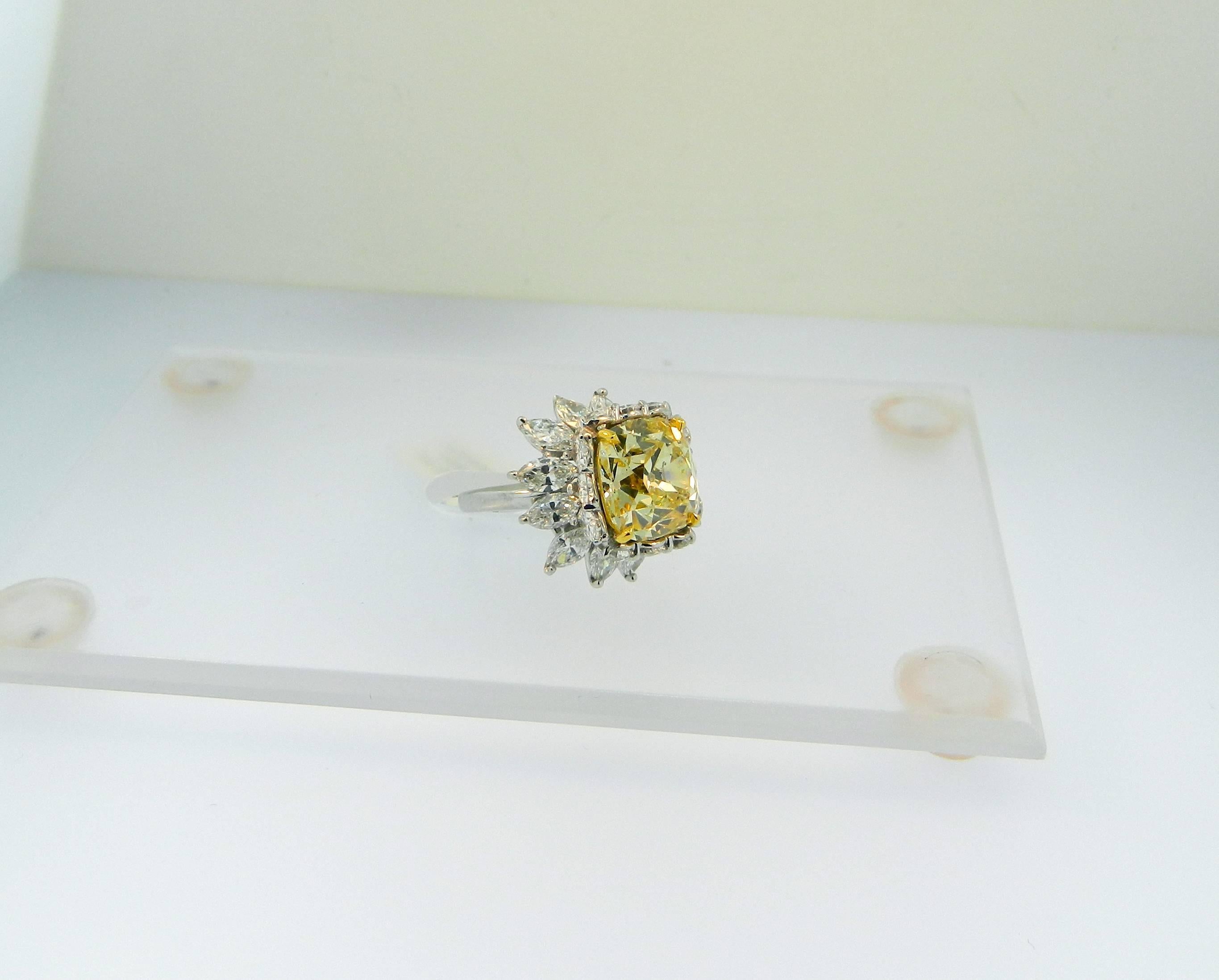 A wonderful and extremely rare GIA certified, antique old mine brilliant cut Fancy Intense Yellow diamond ballerina ring.  Set sometime in the 1950s in platinum, with over 6 carats total weight of fine marquise and pear shape cut diamonds.   The