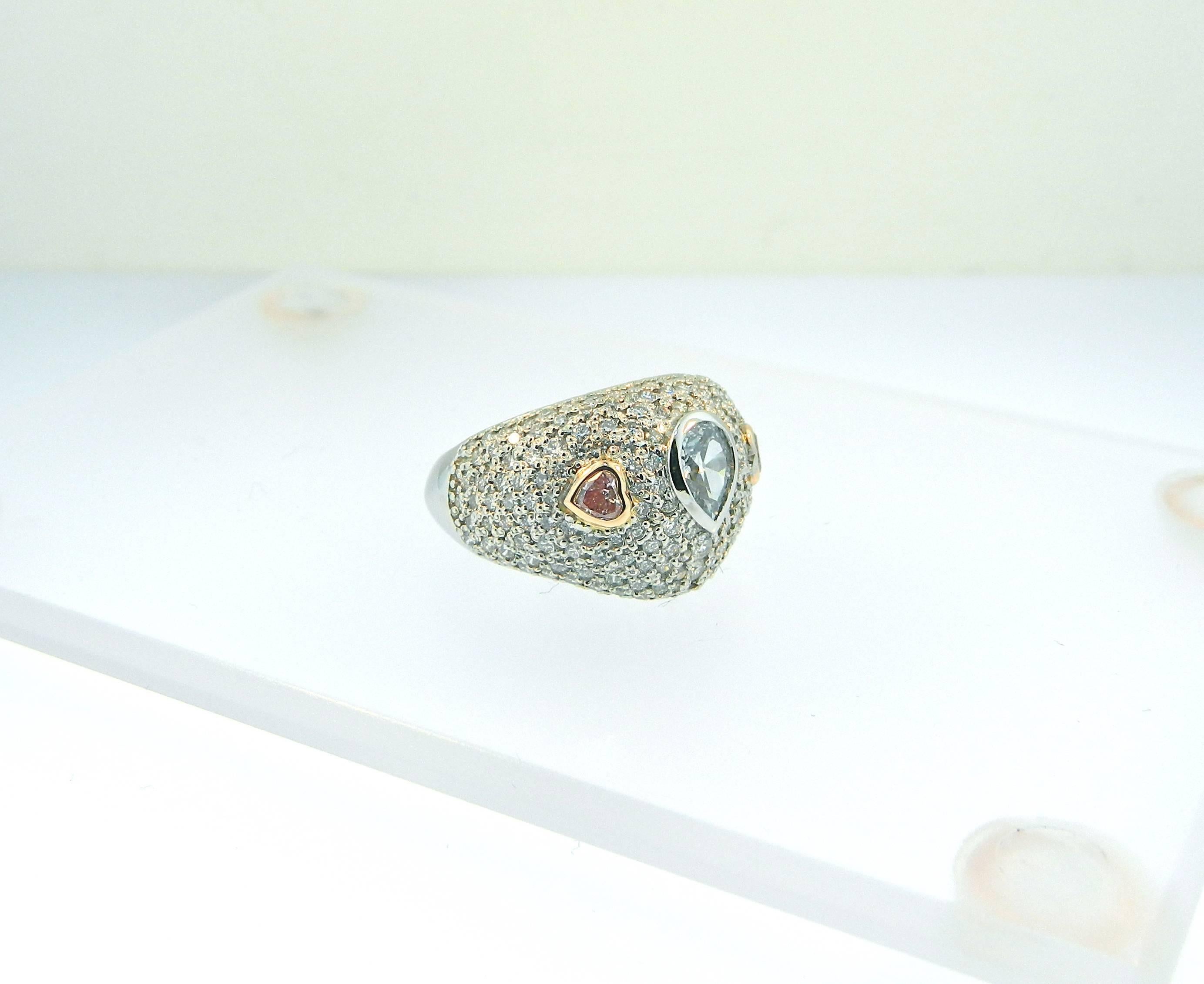 A rare and stunning GIA Certified .54ct Fancy Light Gray-Blue VS2 antique pear shape diamond accented by two natural fancy pink hear shape diamonds.  Mounted in a pave' set platinum and diamond ring.