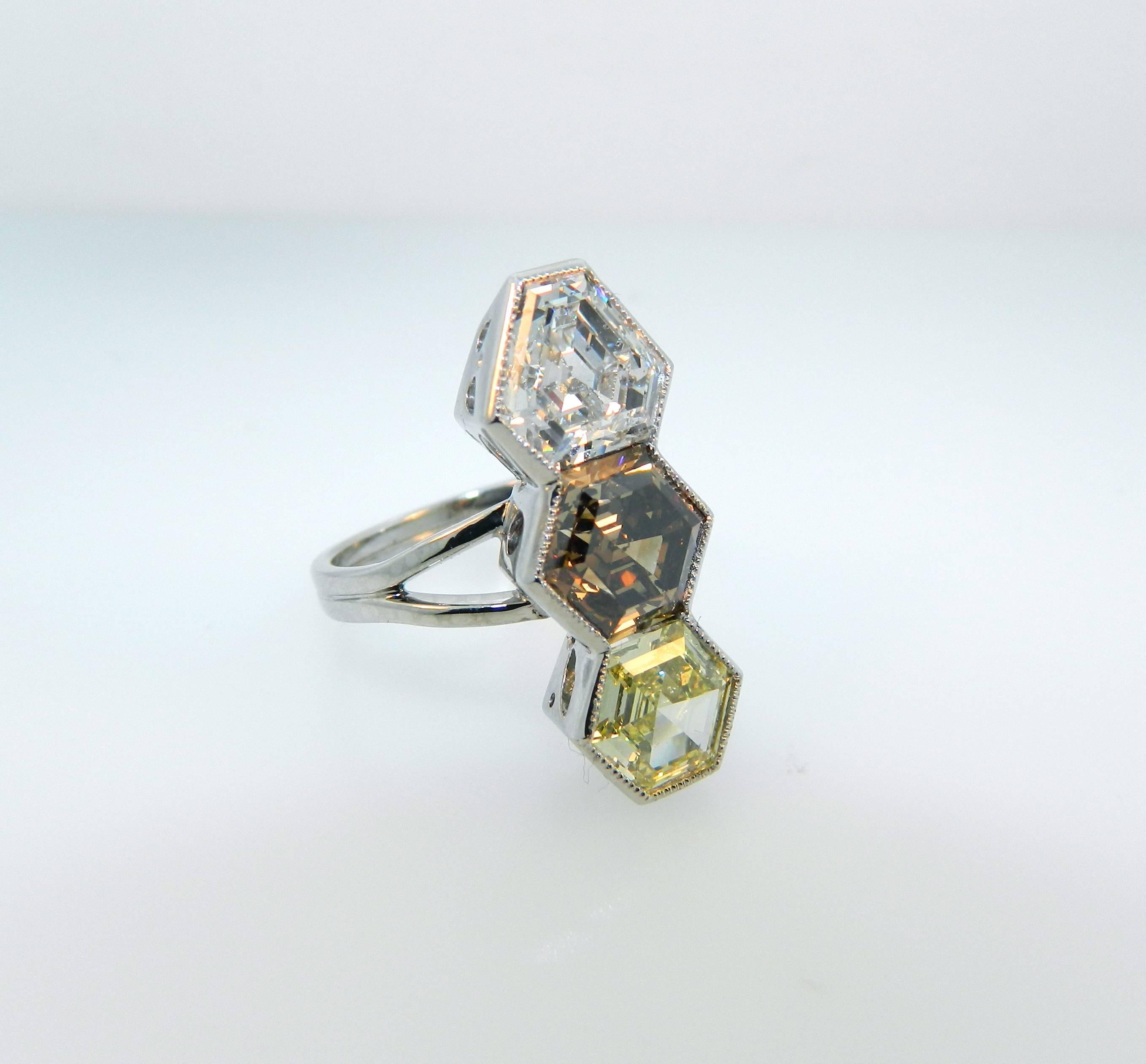 A rare and stunning Hartz & Co Geometric cocktail ring.  This gorgeous ring features a GIA certified 2.30ct E SI1 Modified Shield Step Cut, a 3.01ct Natural Fancy Orangey Brown Hexagonal Step Cut and a GIA certified 1.36ct Natural Fancy Yellow