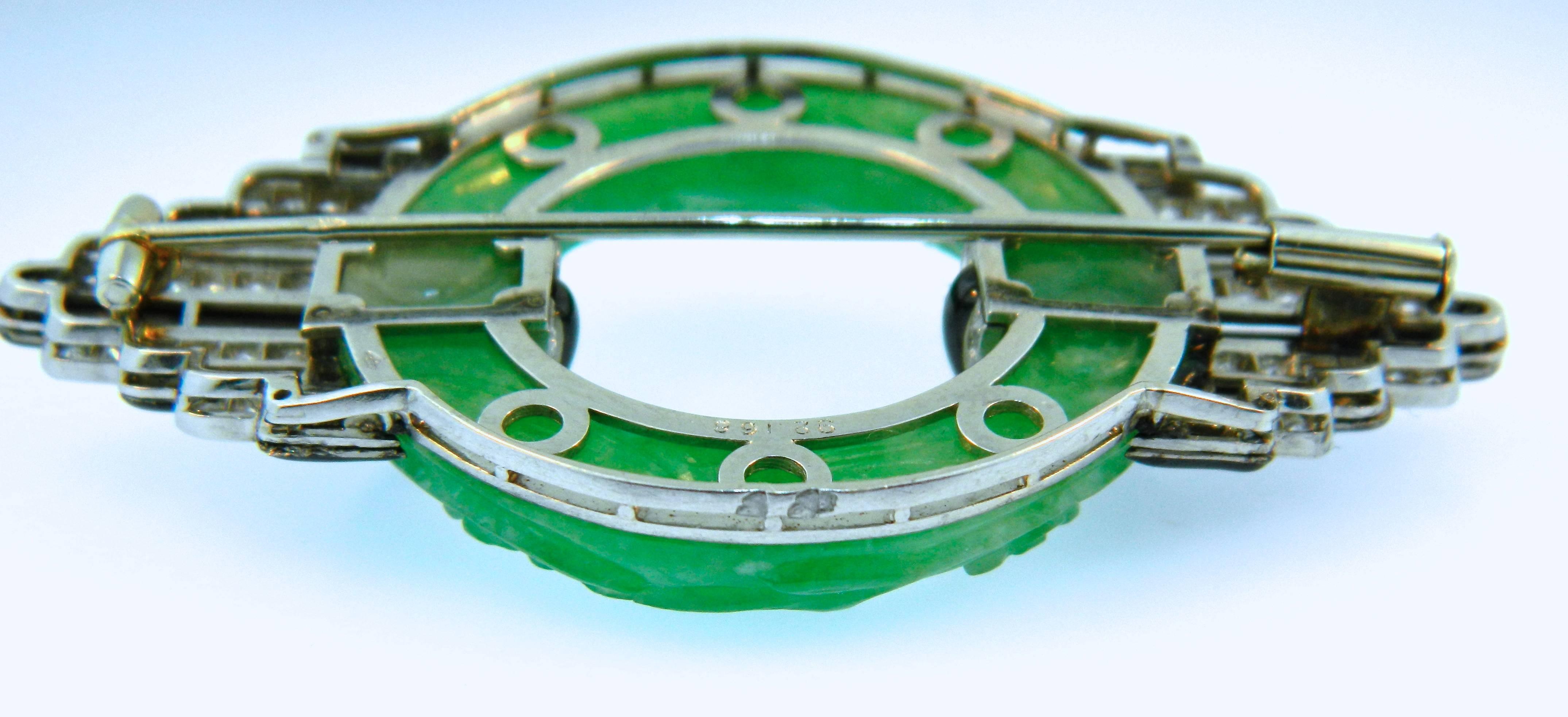 A wonderful French 1920s Art Deco Platinum, Diamond, Onyx and Carved Jadeite Jade Belt Buckle Brooch.  French Marks For Platinum, Maker's Marks and Numbers.  Definitely made by an important and well known french workshop.