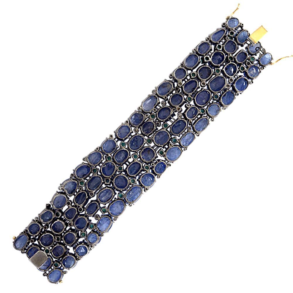 This stunning Blue Sapphire Diamond and Tsavorite Bracelet perfectly wraps around your wrist. All the Blue Sapphire are cabochons and set with prongs. There are 2 safety clasp to close the bracelet with a tongue closure. 

14kt: 6.27gms
Diamond: