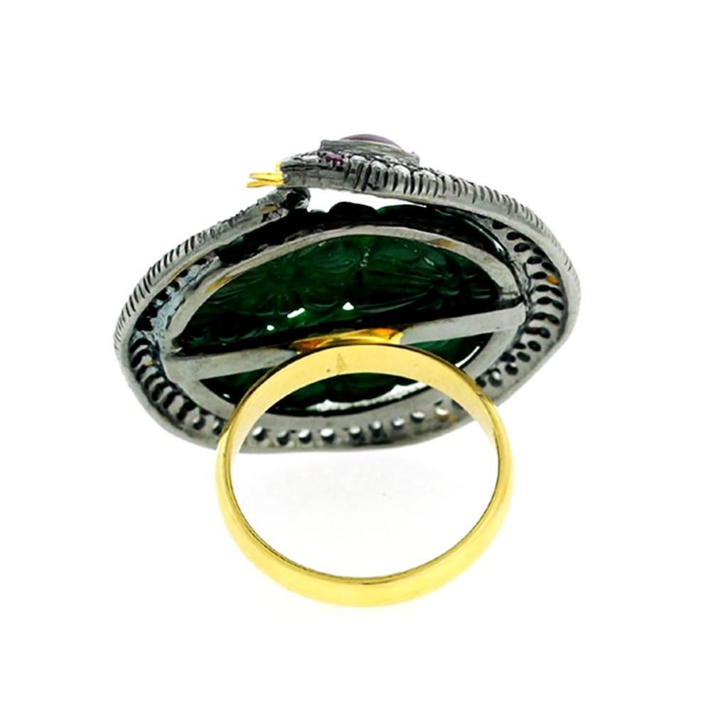 Very attractive and unique Jade and pave diamond on the snake motif wrapped around. Jade is carved with a bunch of flowers and is deep green color.

Ring Size; 7 can be sized

18k:2.8gms
 Diamond: 1.1cts
 Ruby:0.35cts
Jade-13.60cts
