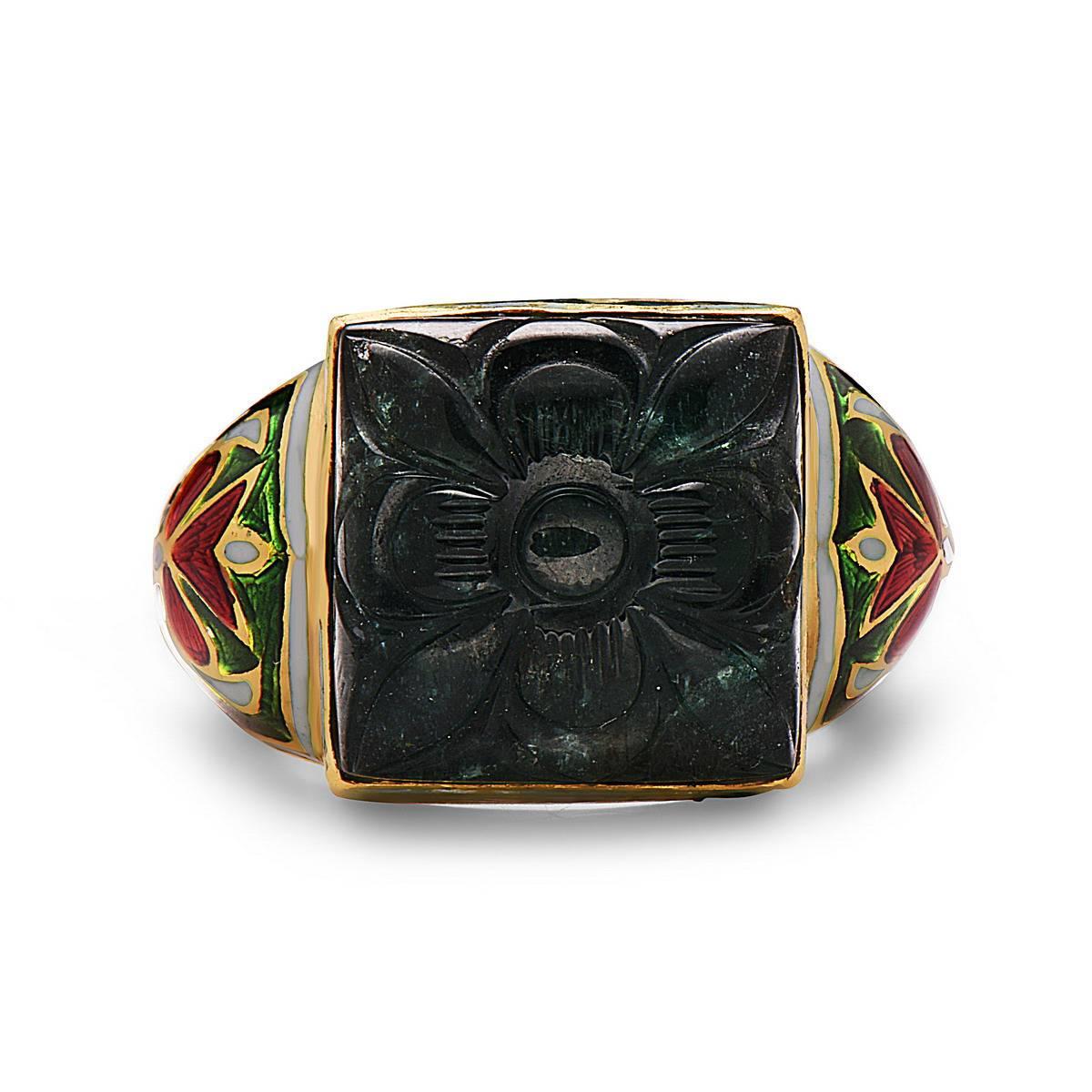 Very Vintage and royal looking ring with carved emerald as center piece and whole of shank in 22K gold enameled with a floral motif. 

Ring Size: 9 ( Can be sized )

22kt: 13.67gs
Emerald: 9.45ct
