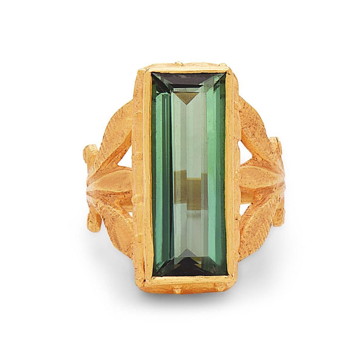 Beautiful handcrafted long green tourmaline baguette ring with a floral shank in 22k Yellow Gold.

Ring Size: 7 ( Can be sized )

22kt: 10.40g
Green Tourmaline: 8.35cts  