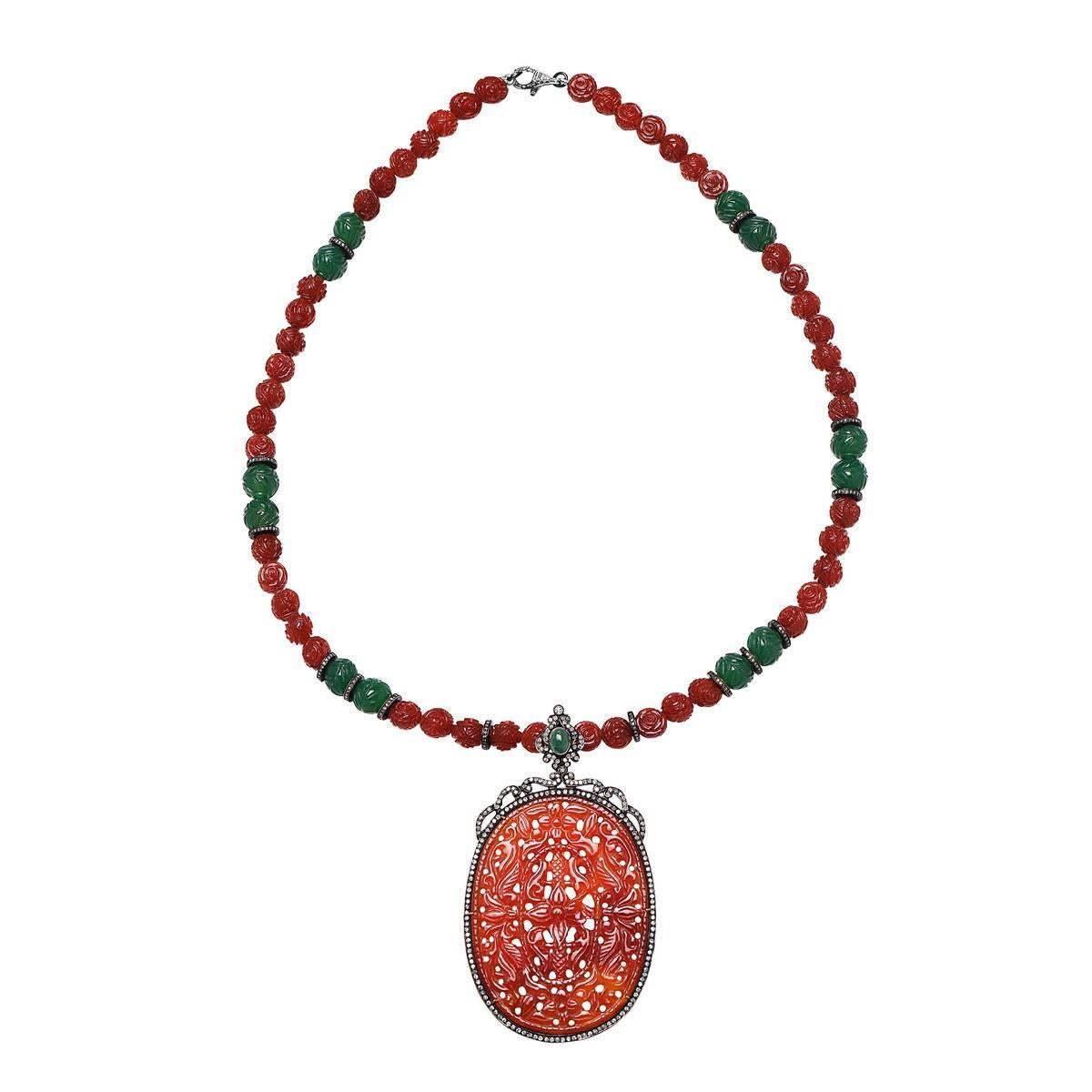 Bold and Beautiful Carved Agate Pendant with pave diamonds around and beautiful motif.. with carved onyx beaded necklace.

D:5.32ct
Slv:27.56gm
Onyx-132.00cts
Agate-388.95cts
Emerald:1.20ct

