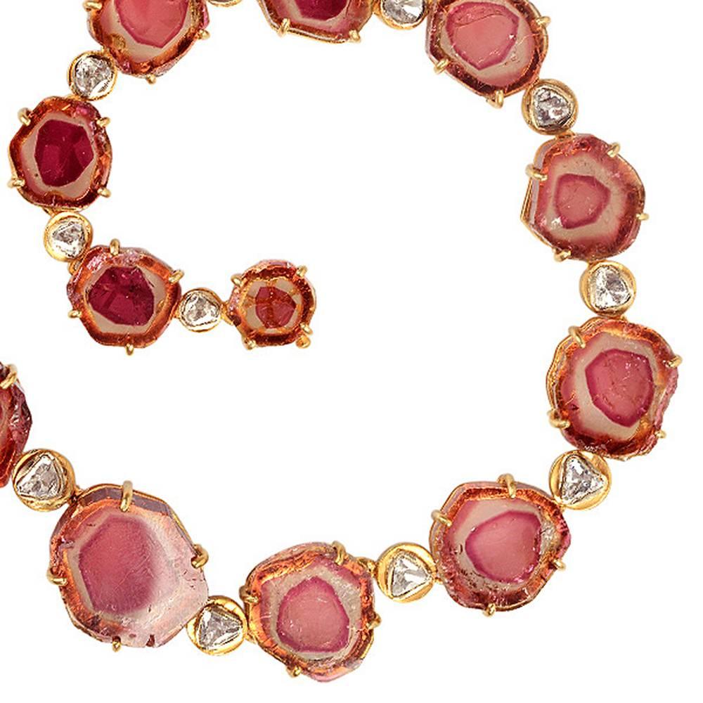One of a kind Watermelon Tourmaline Necklace in gold with Diamonds. This necklace has a perfect assortment of watermelon tourmaline prog set with bezel set rose cut diamonds in between. The closure for this necklace is with a tongue clasp with