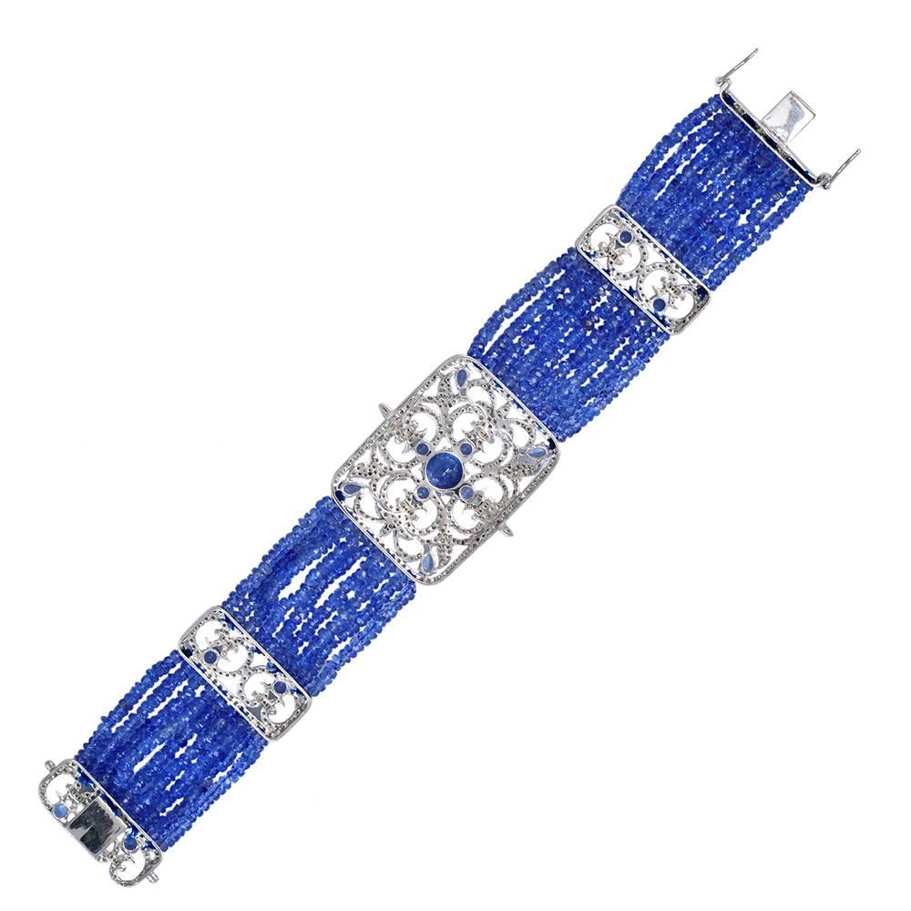 Pretty and perfect delicately hand sewed Tanzanite beads bracelet with Diamond and faceted round Tanzanite motifs all around. the lock is clasp lock with safety locks on both the sides.

18KT: 1.65G
Diamond: 4.46CT
Silver: 17.058G
TANZANITE: 77.7CT
