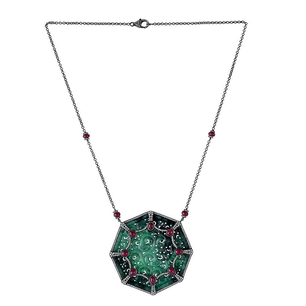 Octagon shape this Carved Jade Necklace with Diamonds and Ruby around is a unique piece. This piece has a chain with diamond ruby motif with lobster clasp as closure.

18KT:0.32G
DIAMOND: 2.17CT
SILVER: 14.949G
RUBY: 10.03CT
JADE: 61.27cts