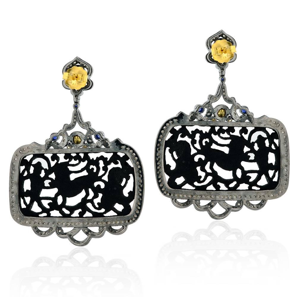 Exclusive Rectangular shape animal carved black jet earring with diamonds around and a pretty top with accents of sapphire and is a unique piece of earring.

Closure: Push Post

18k: 2.04g
Diamond: 4.17ct
Silver: 26.21gm
Sapphire: 2.2ct
Jet: 28.00cts