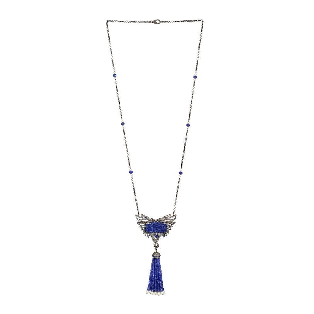 Luxurious looking this long necklace is elegant and a beauty, with carved Tanzanite with feather pattern set with Diamonds with a perfect tassel hanging down with Tanzanite and pearls strand.  

Necklace Closure: Lobster Clasp

18Kt: 0.68g
Diamond: