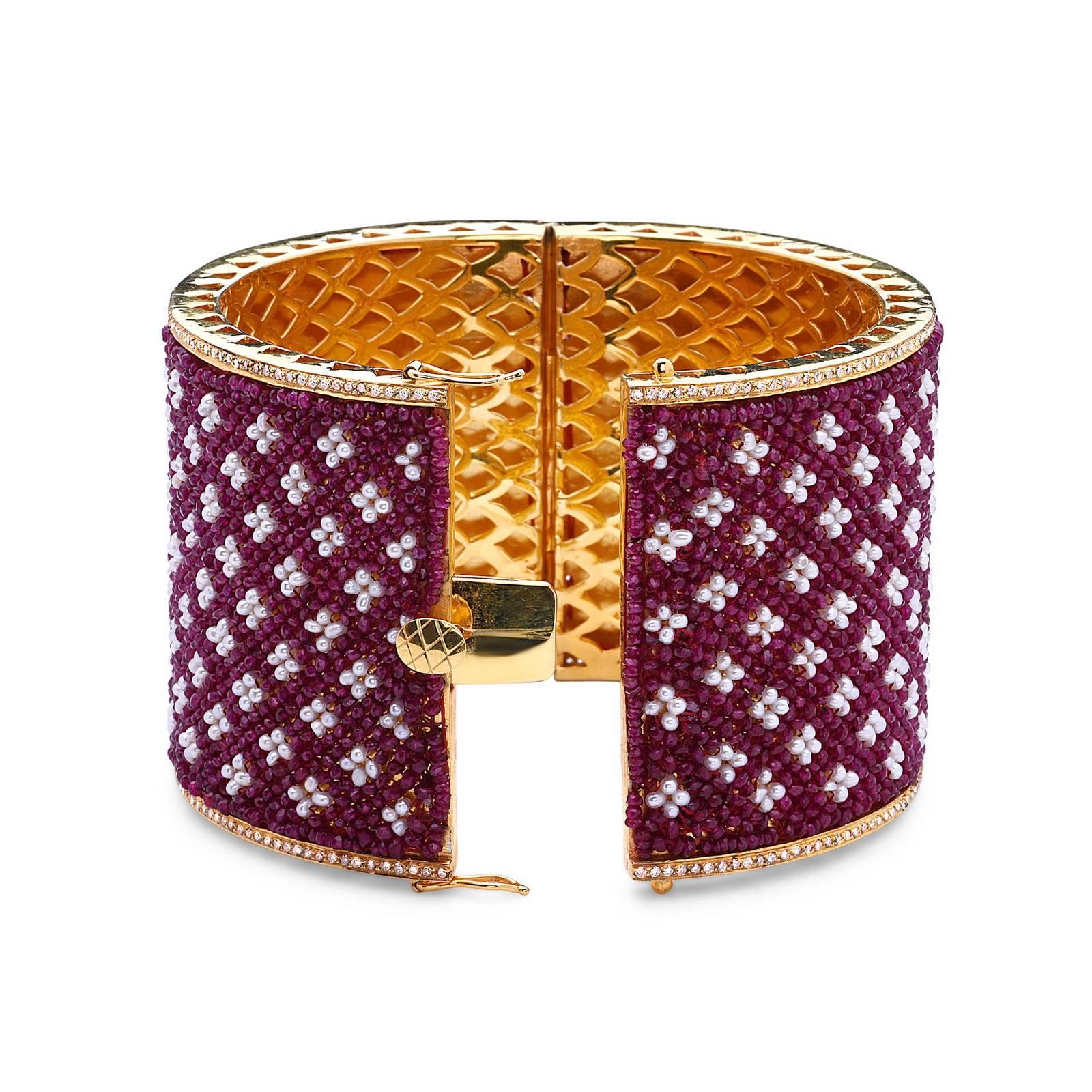 One of It's Kind 14K Yellow Gold & Silver Ruby & Pearl hand sewn 2 inch broad bangle with beautiful hand carved gold design inside the bangle. Total of 115.47cts of Ruby, 2.50cts of Diamonds and 70.45cts of Fresh Water Pearls. A truly owners