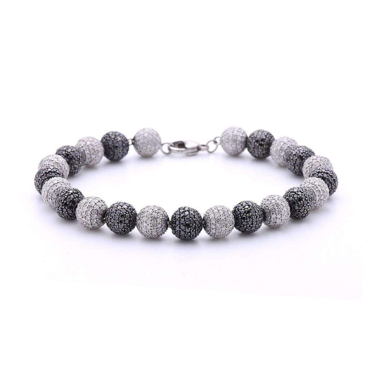 Black & White Diamond Gold Ball Bracelet is an excellent piece to match any of your black outfit. It is 7.5 inch long but the size can be adjusted if requested. The balls are 8mm diamonds set on silver with 18K white gold chain passing through them