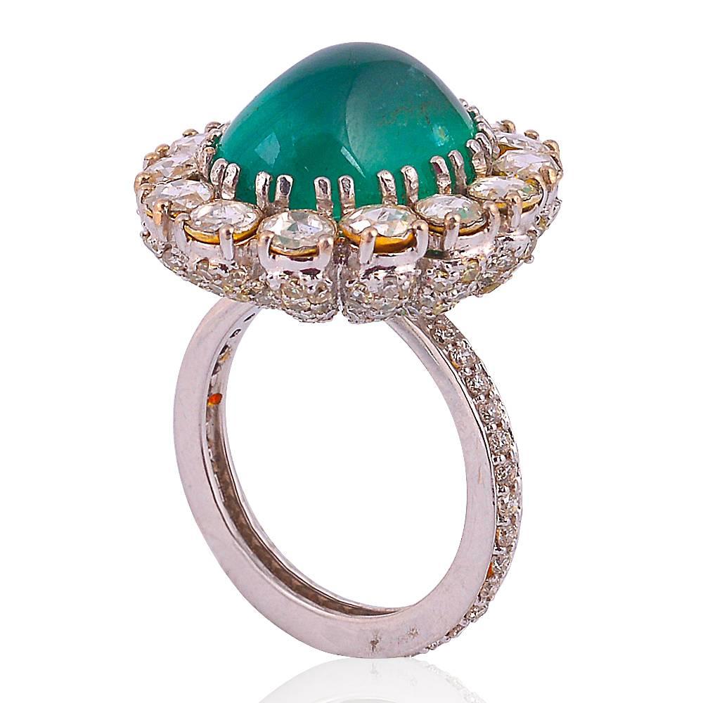This emerald and rose cut diamond cocktail ring is a stunning piece handcrafted by our skilled artisans. It has a 11.19cts of Emerald Cabochon sour rounded by polki diamonds. 
  
Ring size: 7 (can be