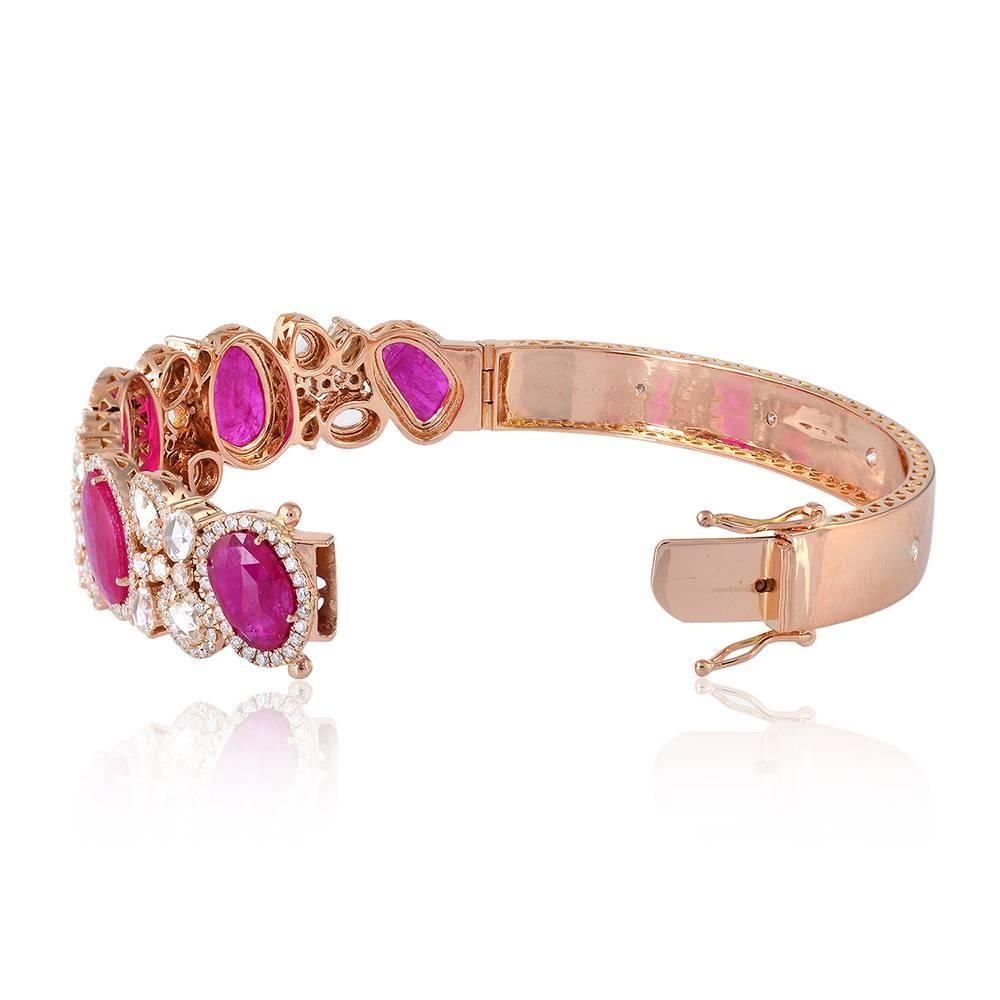 Stunning rose gold ruby stone and diamond oval bangle. It is openable bangle with cluster of diamonds around the ruby. 

18k:29.19gms 
D: 4.4cts 
Ruby:10.2cts