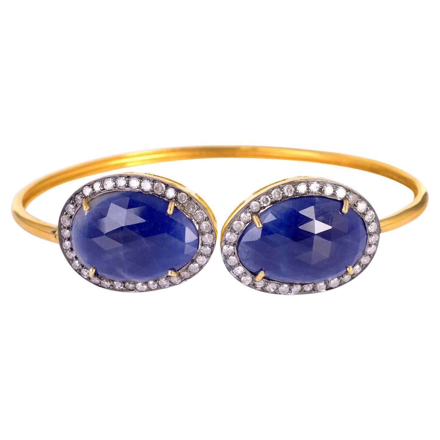 Designer Cuff Bracelet with Blue Sapphire Stones Surrounded by Pave Diamonds For Sale