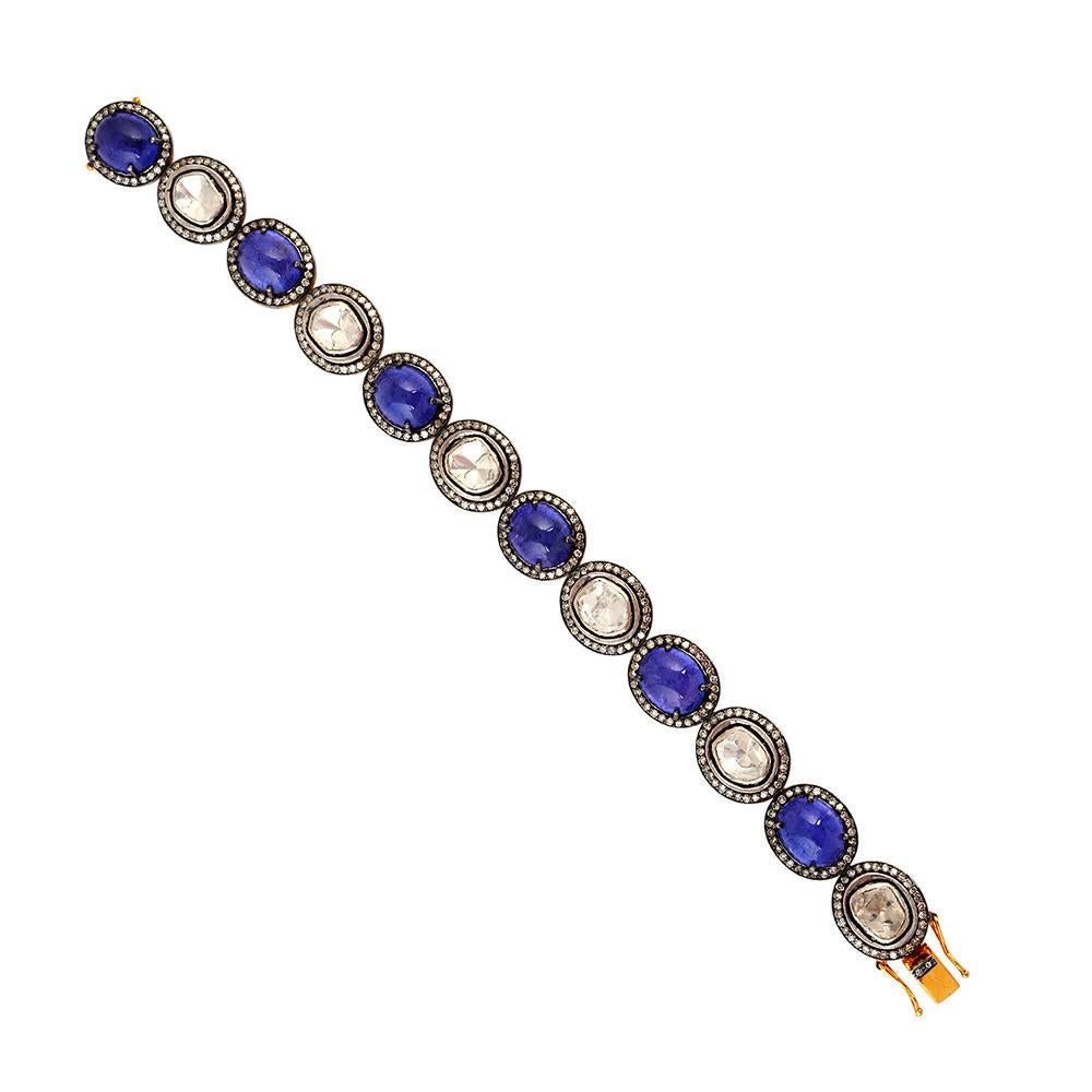 Sleek and simple Cabochon Tanzanite with polki diamonds and pave diamonds around. This bracelet is 7 inch long and has a tounge clasp with 2 safety locks on both the sides. 

14k:4.05g
Diamond: 5cts
Silver:15.95gms
Tanzanite : 29cts
