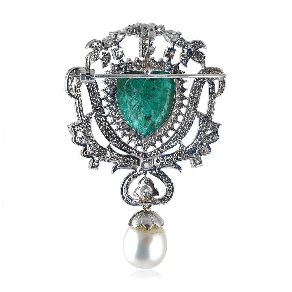 Stylish and royal looking carved Emerald and Diamond Pendant brooch, whicg we bet you can't go wrong with. It's just beautiful and you will look at again and again.. 

18KT Gold: 15.148gms
Diamond: 4.050ct
Emerald: 27.660cts