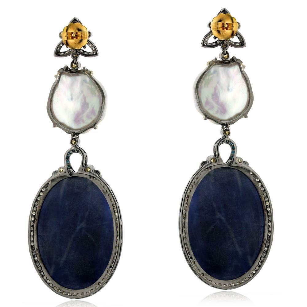 This 2 tier fabulous sliced pearl and blue sapphire earring is a delight with colored diamonds around. This earring has push and post.

18k:2.17 g
Diamond: 4.0 9cts
Slv:16.33 gms
Sapphire: 106 cts
Pearl: 20.30 cts
