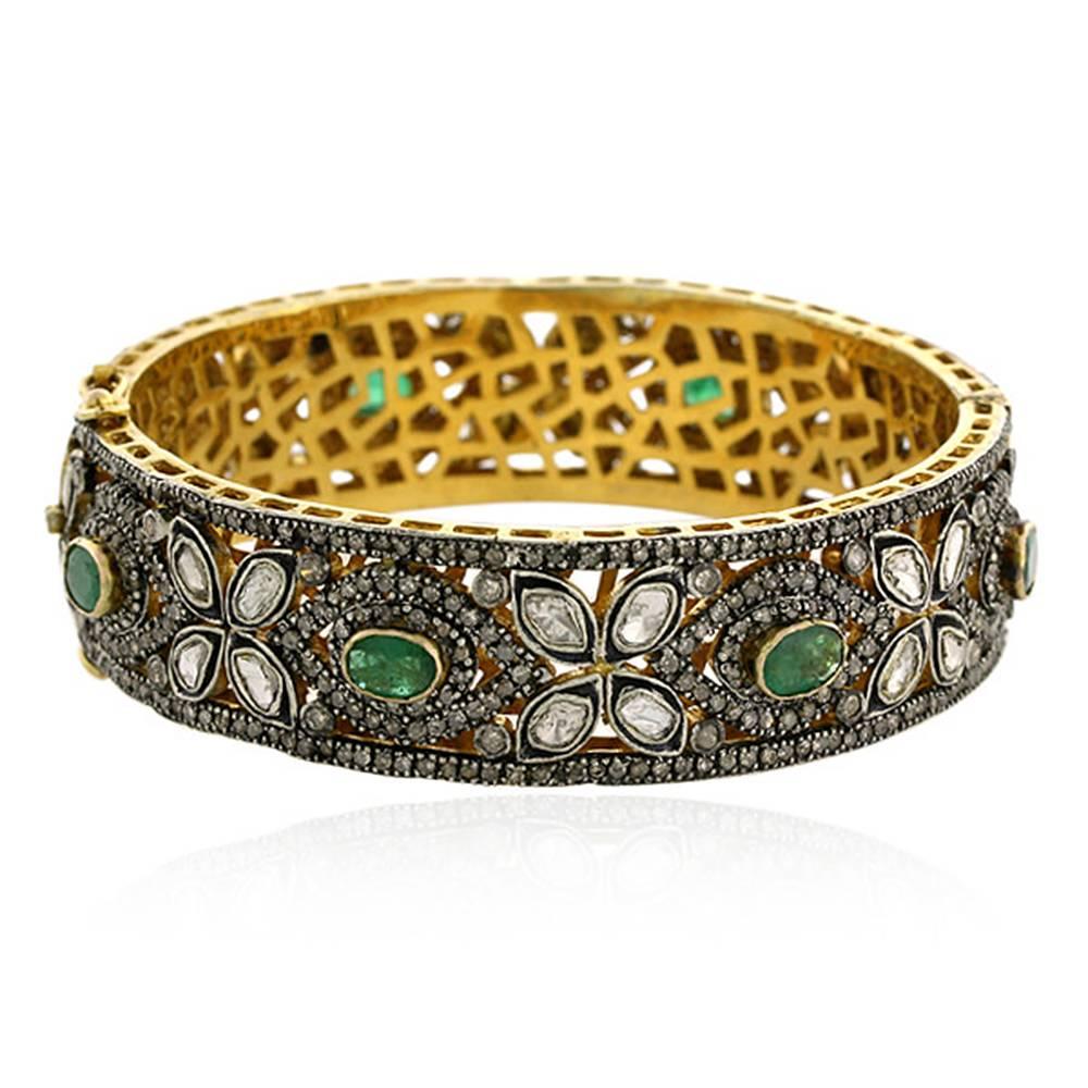 Pretty Rosecut Diamond and Emerald Flower motif bangle. This bangle is openable and has safety clasp on both the sides. Also it has nice gold grill inside. 

14k: 8.77gms
Diamond: 7.12cts
Slv: 33.98gms
Emerald: 5.15cts