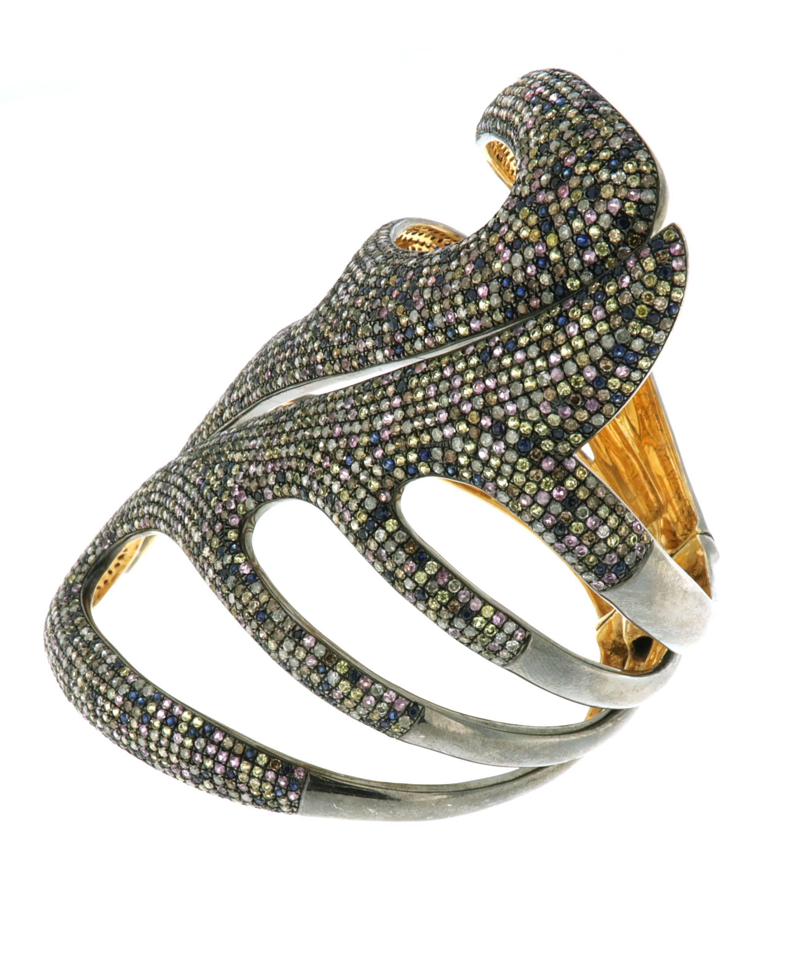 This splendid Multicolor Sapphire and Diamond Cuff is 3.85 inch long on wrist  and opens up on top to wear. 

18kt:0.6gms
Diamond:11.16cts
Slv:80.59gms
Sapphire:15.10cts