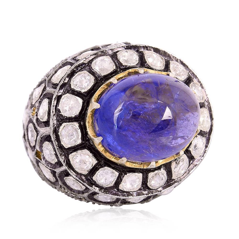 Domed and delightful, this royal looking ring with oval cabochon Tanzanite in center, clawed in center with rose cut diamonds around. This is one of the most attractive rings we have in stock.

Ring Size: 7.25 ( can be sized ) 
18kt: