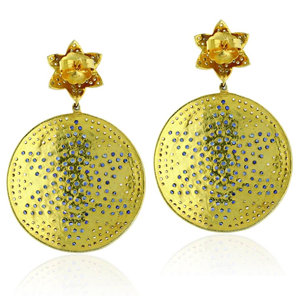 Pretty with floral motifs on studs and pave blue sapphire on the round disc, this earring is a pretty earring for antique looking earring lovers set in silver with gold push and post.

Closure: Push Post 

14k:1.2g
Diamond: 3.28ct
Slv:20.59gm
Blue