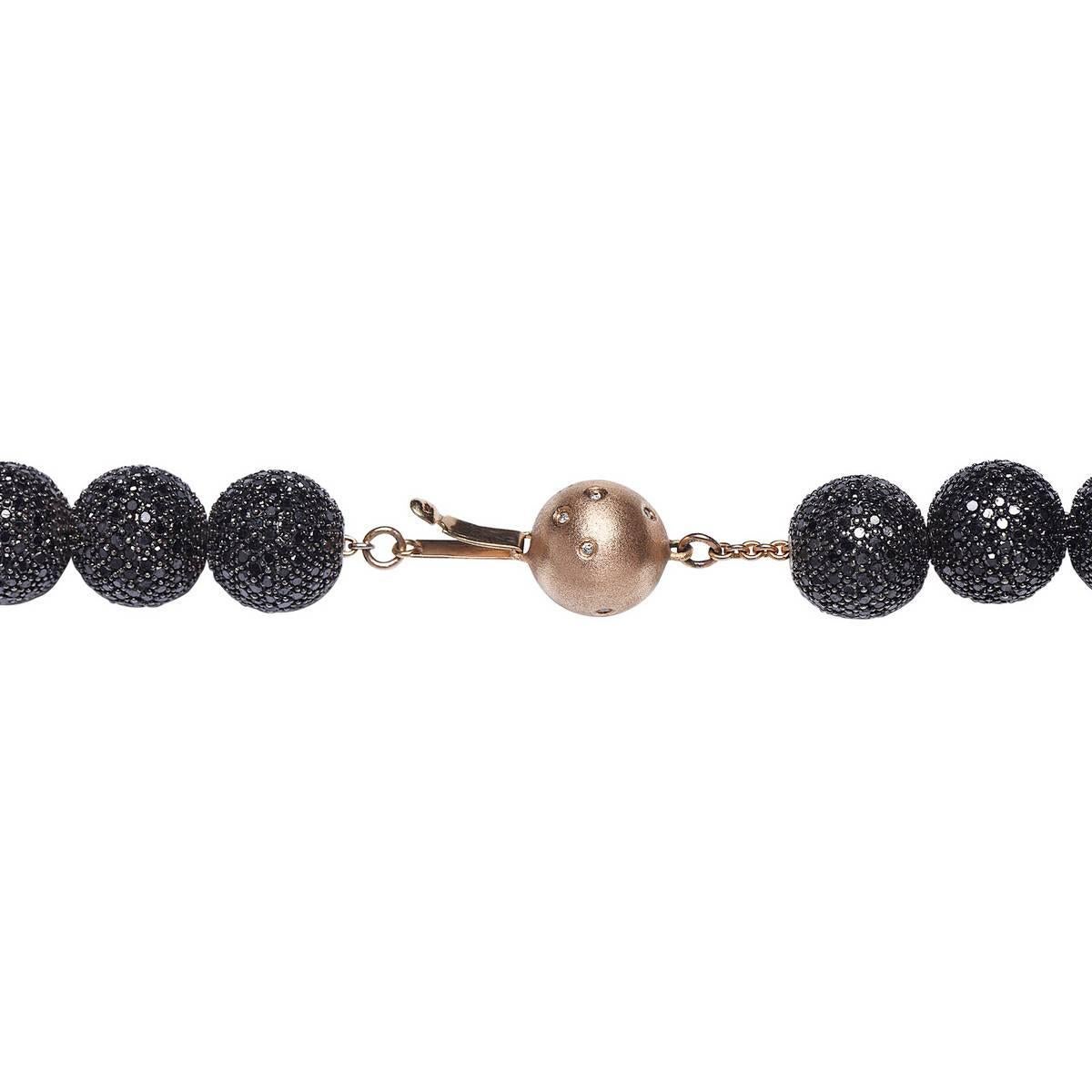 An outstanding piece from our treasure box.. This necklace had 1 white diamond pave ball and 28 black diamond ball with a rose gold clasp with sprinkled diamonds on it. It is a mid night beauty piece.

14kt: 123gms
Diamond: 106ct