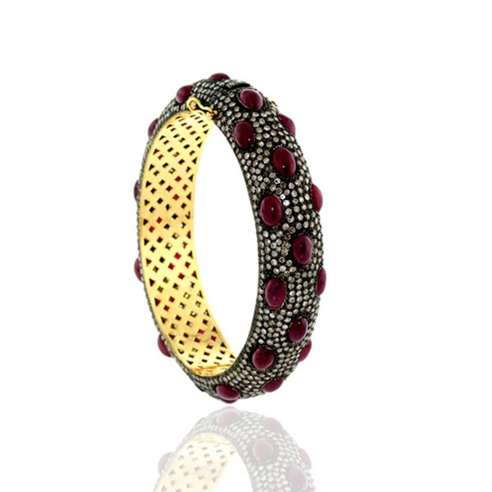 Chic and classy this cabochon ruby with pave diamonds bangle is oval in shape and opens on side and easy to wear on. This bangle has safety clasps on side.


14k:8g
Diamond: 11.55ct
Ruby: 28.12ct