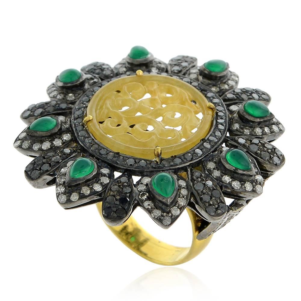 Pretty and flowery designed this Round Carved Jade Ring with Diamonds and Emeralds around is such a delight.

Ring Size: 6.5 ( can be sized )

18k: 4.31g
Diamond: 2.93ct
Slv:11.46gm
Jade- 3.50cts 
Green Onyx-1.1