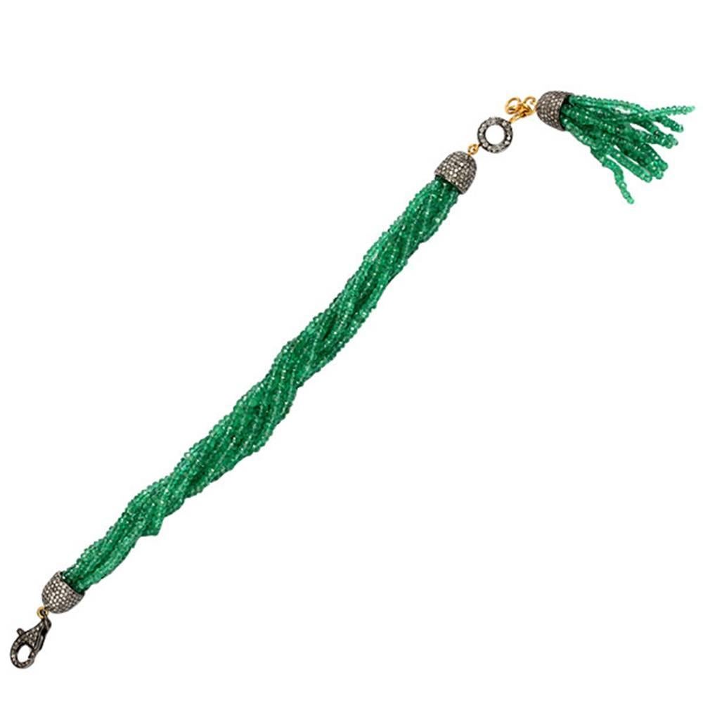 This lovely beaded Emerald  bracelet with a hanging tassel is a very charming piece. You can lock the bracelet with a diamond lobster clasp and the tassel hangs down very beautifully. 

18k:1.25g
Diamond: 3.66ct
Slv:5.97gm
Emerald:99.15ct
