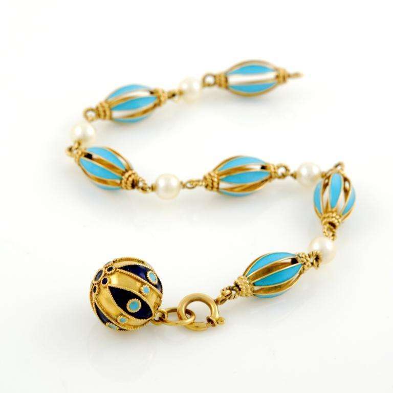 18kt Yellow gold, cultured pearls and blue enamel bracelet with a round pendant at the end. 1940's