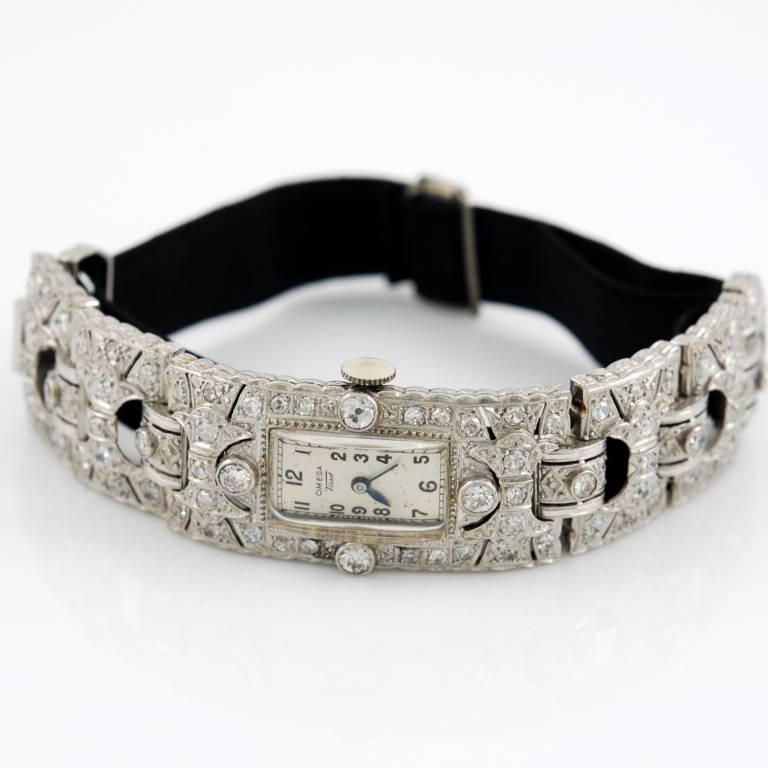 Platinum Art Deco lady's wristwatch by Omega and Tissot with diamonds and black grosgrain strap.
Switzerland, circa 1920