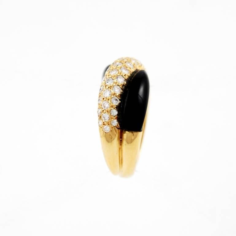 18kt yellow gold, diamond and onyx Van Cleef & Arpels band ring, 1980'S.
The inside is stamped VCA 750
Ring size 6.5, may be resized.