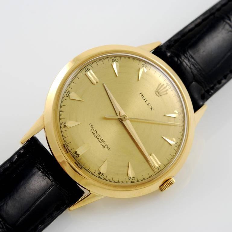 Rolex 18kt yellow gold Precision wristwatch, Ref. 8940, circa 1960s.
Champagne dial with yellow gold applied indexes and triangle markers, 37mm case with plastic crystal, manual-wind mechanical movement.
Leather strap with yellow gold Rolex buckle.