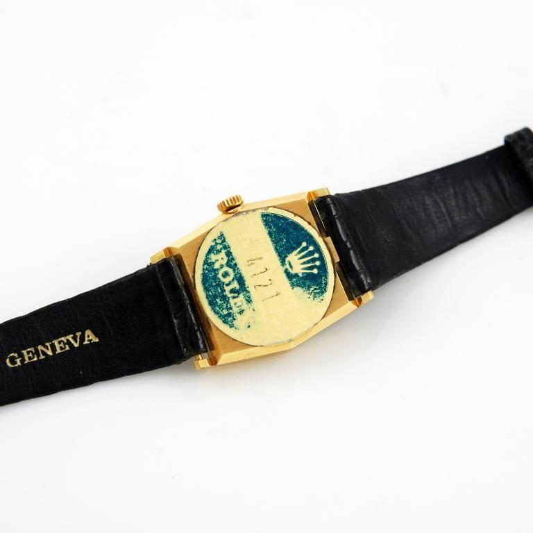 18kt yellow gold Rolex Cellini Lady wristwatch, Ref. 4121.
Cal. 1601 manual wind movement, baton hands and indexes, brushed and polished hexagonal case, black Rolex leather strap with signed gold plated buckle.
Case dimension: 3cm high x 2.5cm