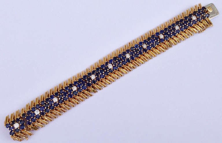 A fine and rare Tiffany & Co. mid-century modern bracelet. Signed flex link yello gold construction features three center rows of sapphires with center row spaced diamonds. 123 prong set sapphires approx. 18.5ctw. 12 brilliant cut prong set diamonds