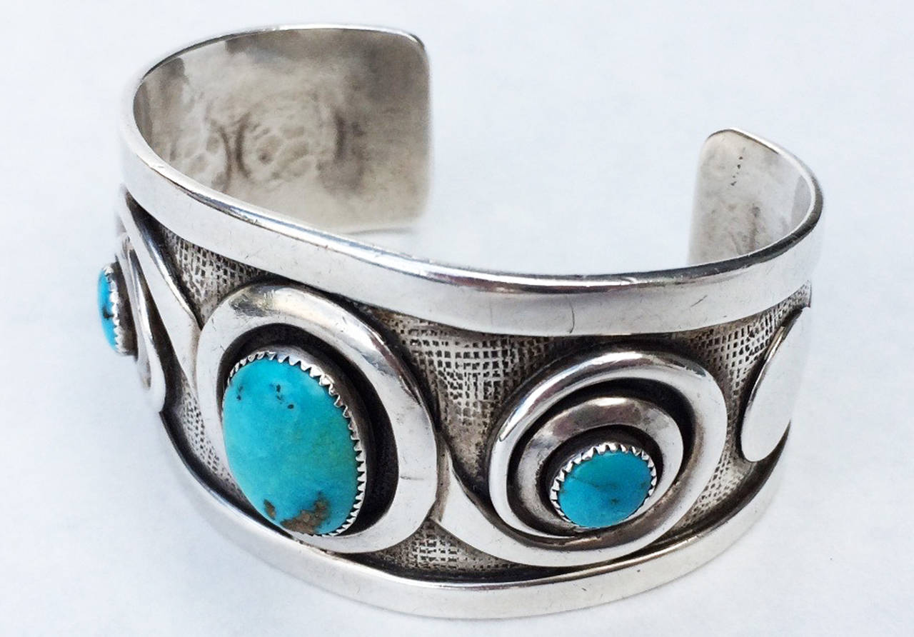 A fine and rare Frank Patania Sr. sterling silver and turquoise cuff bracelet. Signed early item from the iconic Thunderbird Shop (Tucson Arizona). A sculpted fluid sterling cuff features three vivid turquoise cabochon centers. Excellent.