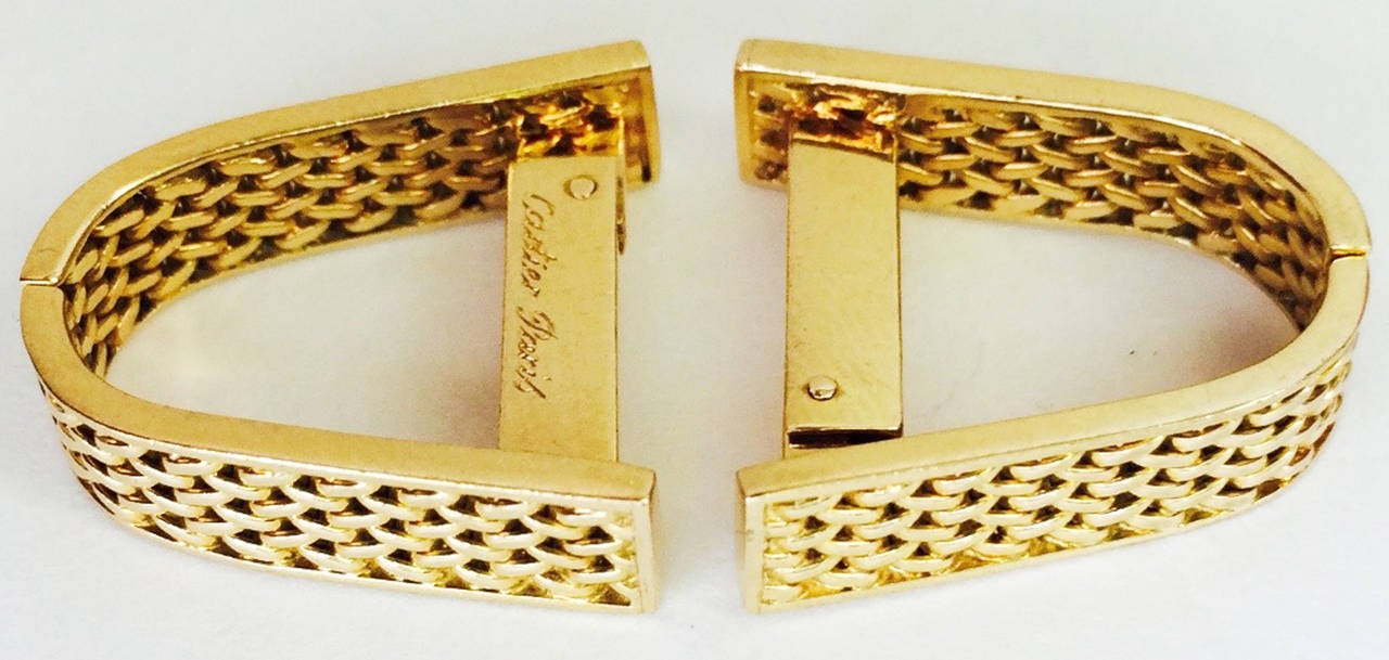 A fine and rare pair of Cartier Paris gold stirrup cuff links. Signed, numbered and hallmarked yellow gold items feature hinged locks. Gorgeous items appropriate for any collection..