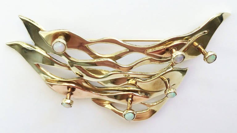 A fine and rare Art Smith modernist gold and opal brooch, New York City ca.1970. A custom ordered one-off item in both yellow and pink gold with stem bezel mounted opals. Signed item retains original pin back. A rare and seldom seen Art Smith gold