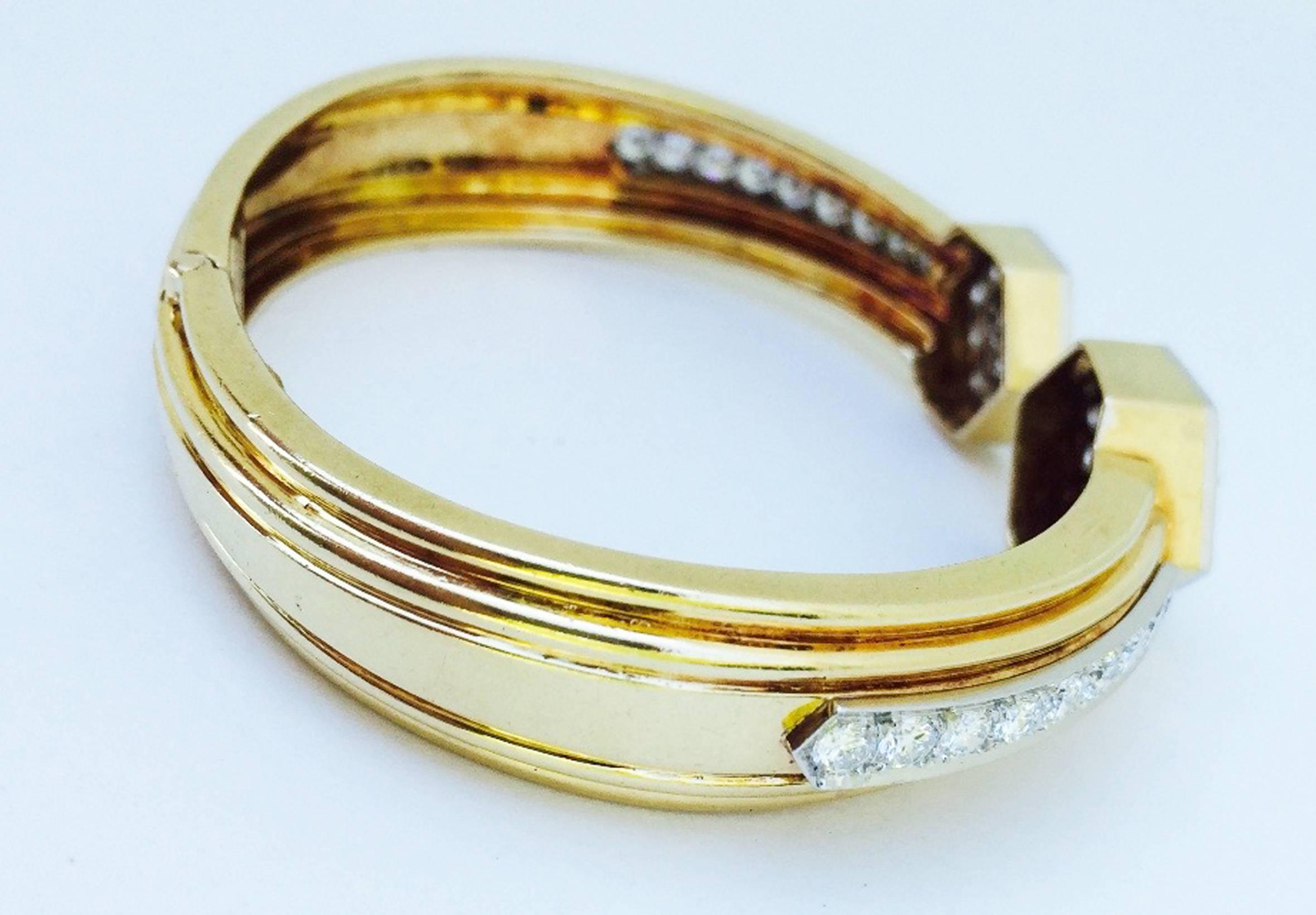 A exquisite David Webb diamond clamper cuff bracelet. Signed 18K yellow gold and platinum hinged item features two opposing diamond set (approx. 7.5 ctw) 